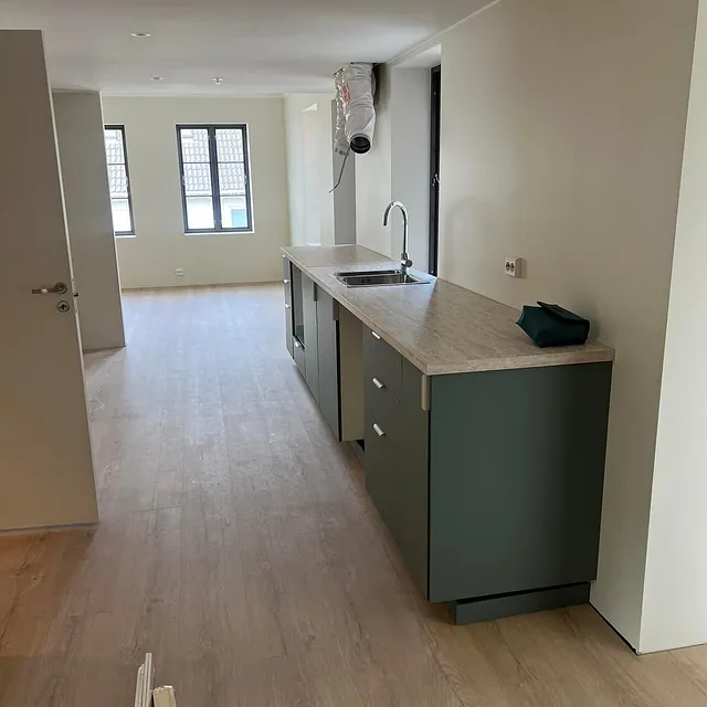 Grønt kjøkken i lyst rom